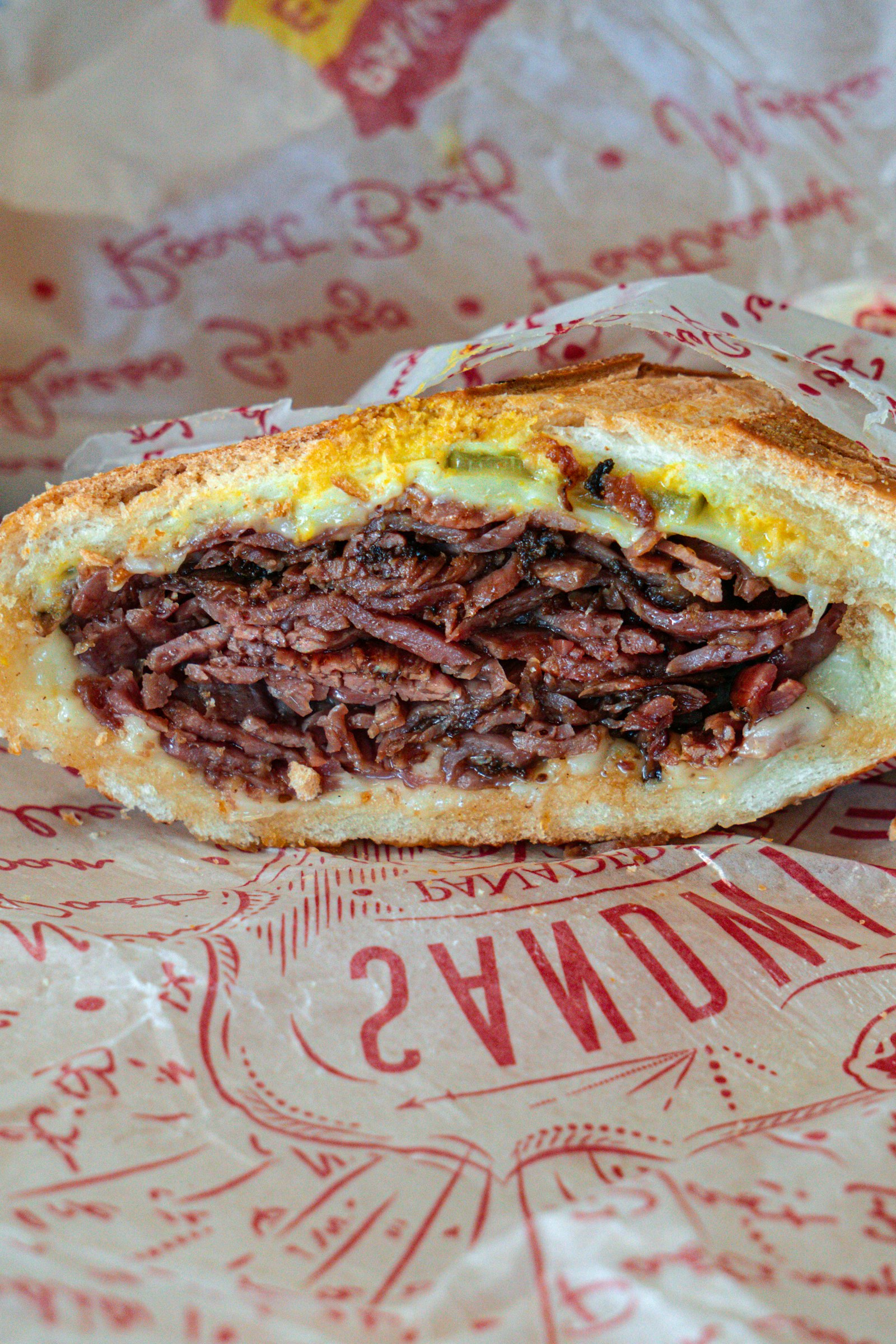 A thick pastrami sandwich on rye, stacked and ready to eat